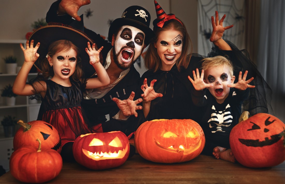 happy family mother father and children in costumes and makeup on  Halloween